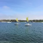 The Sail Newport boats sit waiting to instruct near Fort Adams in Newport RI