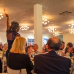 Betty Mae Mosley wins a great auction prize at the Northeast Region Porsche Club annual gala