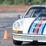 Tom Tate navigates the autocross cones in his Martini livery classic Porsche 911